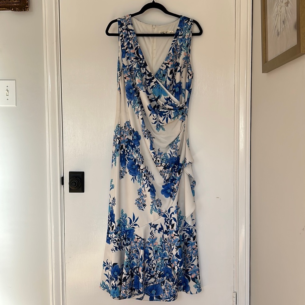 Eliza J White with blue flowers with pink petal accents.